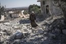 A Syrian man walks among rubble of destroyed residential buildings minutes after an airstrike hit Habit village, in the Syrian central province of Hama, Wednesday, Sep. 25, 2013. (AP Photo)
