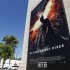 A poster for "The Dark Knight Rises" is displayed in Burbank