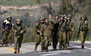 Israeli soldiers carry an injured comrade after an &hellip;