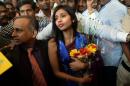 Indian diplomat Devyani Khobragade (R) arrives at the domestic airport in Mumbai on January 14, 2014