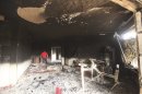A man walks inside the U.S. consulate, which was attacked and set on fire by gunmen yesterday, in Benghazi