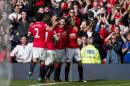 Manchester United's Radamel Falcao Garcia, right, celebrates with teammates after scoring against Everton during their English Premier League soccer match at Old Trafford Stadium, Manchester, England, Sunday Oct. 5, 2014. (AP Photo/Jon Super)