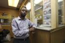 Hussein stands at the counter of his money transfer business Mustaqbal Express in Minneapolis