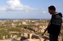 A young Libyan man stands guard in the ancient Roman city of Leptis Magna in al-Khums, 130 km east of the capital Tripoli