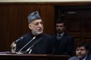Afghan President Hamid Karzai speaks during his final address to parliament during its opening session at the parliament house in Kabul, Afghanistan, Saturday, March 15, 2014. Karzai said the last 12 years of war were "imposed" on Afghans, a reference to the U.S.-led invasion that ousted the Taliban. (AP Photo/Rahmat Gul)