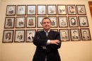 File photo shows Serbian Socialist leader Dacic posing in front of photos of former Serbian interior ministers at his office in Belgrade