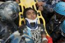 Earthquake survivor is rescued by the Armed Police Force from the collapsed Hilton Hotel, a result of an earthquake in Kathmandu