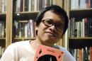 Author Eka Kurniawan showing off his book "Man Tiger"