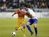 Barcelona's Andres Iniesta fights for the ball with Deportivo Alaves' Guzman Casaseca during their Spanish King's Cup soccer match in Vitoria