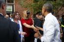 President Barack Obama greets a man wearing a horse mask during a stroll in Denver.