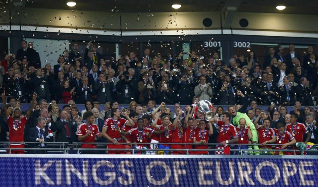Bayern Munich's Philipp Lahm lifts the trophy as he stands with team mates after defeating Borussia Dortmund in their Champions League Final soccer match at Wembley Stadium in London