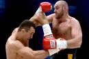 Ukrainian World heavyweight boxing champion Wladimir Klitschko (L) and Britain's Tyson Fury compete during their WBA, IBF, WBO and IBO title fight in Dusseldorf, western Germany, on November 28, 2015