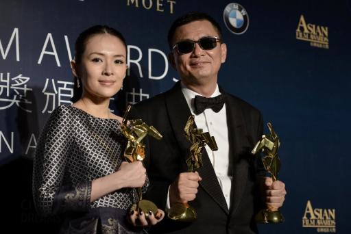 Winner of best film and best director, Hong Kong filmmaker Wong Kar-wai (R), and best actress winner Zhang Ziyi of China pose during the Asian Film Awards in Macau on March 27, 2014