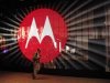 A man walks by a video display at the Motorola booth on the second day of the Consumer Electronics Show (CES) in Las Vegas