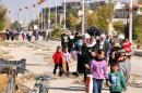 Syrian civilians evacuate Moadamiyet al-Sham on October 29, 2013