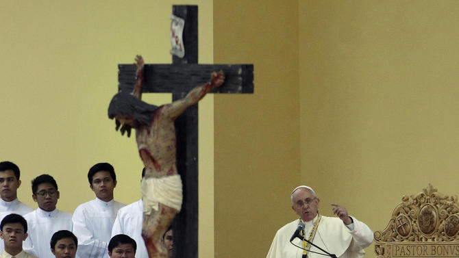 Pope Francis gestures as he delivers a message during his meeting with the youth at the University of Santo Tomas in Manila, Philippines on Sunday, Jan. 18, 2015. Millions filled Manila's main park and surrounding areas for Pope Francis' final Mass in the Philippines on Sunday, braving a steady rain to hear the pontiff's message of hope and consolation for the Southeast Asian country's most downtrodden and destitute. (AP Photo/Aaron Favila)