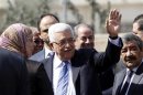 Palestinian President Abbas waves as he arrives at a polling station in Al-Bireh