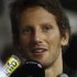 Lotus F1 Formula One driver Romain Grosjean of France speaks to journalists in the paddock ahead of the Singapore F1 Grand Prix