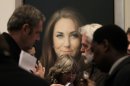 Members of the media talk to artist Paul Emsley, center right, in front of his newly-commissioned portrait of Kate, Duchess of Cambridge, on display at the National Portrait Gallery in London, Friday, Jan. 11, 2013. (AP Photo/Sang Tan)