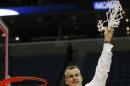 Florida head coach Billy Donovan holds the net after the second half in a regional final game against Dayton at the NCAA college basketball tournament, Saturday, March 29, 2014, in Memphis, Tenn. Florida won 62-52. (AP Photo/John Bazemore)