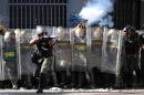 A National Guard member shoots tear gas during an opposition demonstration against the government of Venezuelan President Nicolas Maduro, in Caracas on February 12, 2014