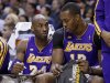Los Angeles Lakers guard Kobe Bryant, left, draws a play for center Dwight Howard as they sit on the bench in the first half of an NBA basketball game against the Indiana Pacers in Indianapolis, Friday, March 15, 2013.  (AP Photo/Michael Conroy)