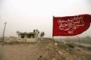 Shi'ite militia flag bearing a verse from the Koran is seen on the outskirts of Diyala province, north of Baghdad