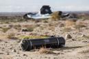 A tank, part of wreckage lies near the site where a Virgin Galactic space tourism rocket, SpaceShipTwo, exploded and crashed in Mojave, Calif. Saturday, Nov 1, 2014. The explosion killed a pilot aboard and seriously injured another while scattering wreckage in Southern California's Mojave Desert, witnesses and officials said. (AP Photo/Ringo H.W. Chiu)