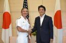 Admiral Harry B. Harris Jr, (L), Commander of United States Pacific Command, is welcomed by Japanese Prime Minister Shinzo Abe (R) during a courtesy call at Abe's official residence in Tokyo on July 26, 2016