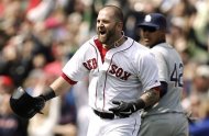 Boston Red Sox's Mike Napoli celebrates after his game-winning double as Tampa Bay Rays' Yunel Escobar watches during the ninth inning of a baseball game at Fenway Park in Boston on Monday, April 15, 2013. Boston won 3-2. (AP Photo/Winslow Townson)