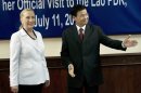 U.S. Secretary of State Hillary Rodham Clinton, left, is greeted by Laotian Deputy Prime Minister and Foreign Minister Thongloun Sisoulith before a meeting at the Ministry of Foreign Affairs in Vientiane, Laos Wednesday, July 11, 2012. Clinton is making a historic visit to Laos, the first by a U.S. secretary of state in more than five decades. (AP Photo/Brendan Smialowski, Pool)