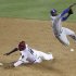 Los Angeles Dodgers shortstop Dee Gordon, right, leaps to avoid the slide by Arizona Diamondbacks' Justin Upton, left, to complete a double play for the final outs of the game in the ninth inning of a baseball game Tuesday, May 22, 2012, in Phoenix. The Dodgers won 8-7.(AP Photo/Paul Connors)
