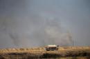 Smoke rises from clashes with Islamic State militants in Falluja
