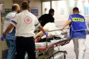 An injured person is taken into emergency room following a shooting attack that took place in the center of Tel Aviv