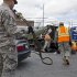New York National Guard personnel prepare to pump gas into a vehicle as up to ten gallons of free gas is given away in the Jamaica neighborhood of the Queens borough of New York, Saturday, Nov. 3, 2012, in the wake of Superstorm Sandy. Trucks are being provided by the U.S. Department of Defense at the direction of President Barack Obama and are being deployed in coordination with the New York National Guard at the direction of the governor. (AP Photo/Craig Ruttle)