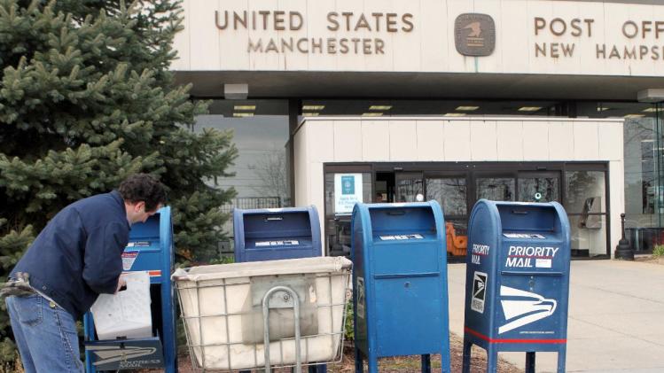 A postal worker collects mail in front of the Post Office, Monday, Dec. 5, 2011 in Manchester, N.H. The office is one of many that could be closed when he estimated $3 billion in reductions takes effect.  (AP Photo/Jim Cole)