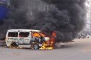 A minibus is set ablaze during a clash between Islamist activists and police in Dhaka
