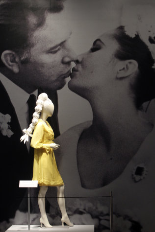 A Sunflower Yellow Chiffon wedding dress for her first marriage to Richard Burton is on display during a preview of the full Collection of Elizabeth Taylor at Christie's, Thursday, Dec. 1, 2011 in New York. The collection will be up for auction in person and online, a first for Christie's, from Dec. 13-17. (AP Photo/Mary Altaffer)