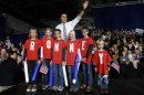 Republican presidential candidate and former Massachusetts Gov. Mitt Romney poses with children wearing shirts which spell out "Romney" as he campaigns at the Iowa Events Center, in Des Moines, Sunday, Nov. 4, 2012. (AP Photo/Charles Dharapak)