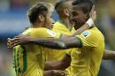Brazil's Neymar celebrates with Brazil's Luiz Gustavo, right, after scoring his side's first goal during the group A World Cup soccer match between Cameroon and Brazil at the Estadio Nacional in Brasilia, Brazil, Monday, June 23, 2014. (AP Photo/Bernat Armangue)