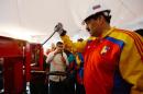 Venezuelan President Nicolas Maduro destroys weapons during an event to promote a public disarmament program, at "23 de Enero" (January 23), a poor neighbourhood of Caracas, on August 8, 2013