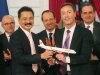 FILE - In this Monday, March 18, 2013 file photo, Lion Air President and chief executive Rusdi Kirana of Indonesia, second left, and Airbus President and chief executive Fabrice Bregier, second right, pose with an Airbus 320 model for the media while France's President Francois Hollande, center, applauds with others during a signing ceremony at the Elysee Palace in Paris when the Indonesian airline announced to buy 234 Airbus plane for 18.4 billion Euro ($24 billion). Indonesia's top discount carrier, which catapulted into the global aviation spotlight with record deals to buy Airbus and Boeing planes, is taking the battle for Asia’s budget-minded travelers to the backyard of the airline that helped pioneer low cost flights in the region. (AP Photo/Michel Euler, File)