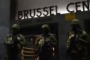 Soldiers stand guard in front of the central train station on November 22, 2015 in Brussels