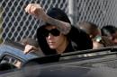 Justin Bieber prepares to stand on his vehicle after exiting from the Turner Guilford Knight Correctional Center on January 23, 2014 in Miami, Florida