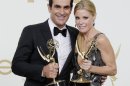 FILE - This Sept. 18, 2011 file photo shows Ty Burrell, left, Julie Bowen from the television series "Modern Family" holding their Emmys for best supporting and actress actress in a comedy, backstage at the 63rd Primetime Emmy Awards in Los Angeles. Five stars of the hit ABC series sued 20th Century Fox Television on Tuesday July 24, 2012, claiming their contracts with the studio are illegal under California law and should be invalidated. (AP Photo/Jae Hong, file)
