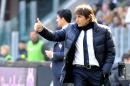 Juventus coach Antonio Conte gestures during a Serie A soccer match between Juventus and Fiorentina at the Juventus stadium, in Turin, Italy, Sunday, March 9, 2014. (AP Photo/Massimo Pinca)