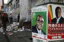 Election campaign posters are pictured near Zimbabweans walking on a street blocked by uncollected garbage in Harare