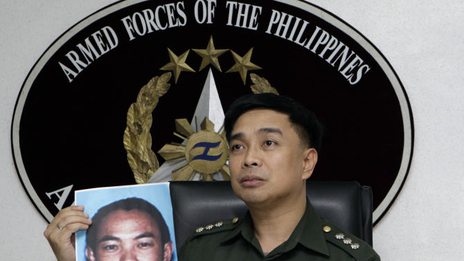 FILE - In this Feb. 2, 2012 file photo, then Armed Forces of the Philippines spokesman Col. Marcelo Burgos shows a picture of Malaysian Zulkifli bin Hir, also known as Marwan, during a press conference in suburban Quezon City, north of Manila, Philippines. Southeast Asia&#39;s top terrorist suspect has evaded capture and survived several military assaults in the southern Philippines, where police now await DNA results to confirm if he is the man killed in the Jan. 25, 2015 raid that also left 44 police commandos dead.  (AP Photo/Pat Roque, File)