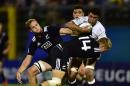 New Zealand's Jack Goodhue (R) tackles England's Lewis Ludlam (2nd R) during the World Rugby U20 Championship final match on June 20, 2015 at the Giovanni Zini stadium in Cremona