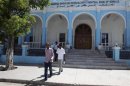 People walk outside Somalia's central Bank in Hamarwayne district, south of capital Mogadishu